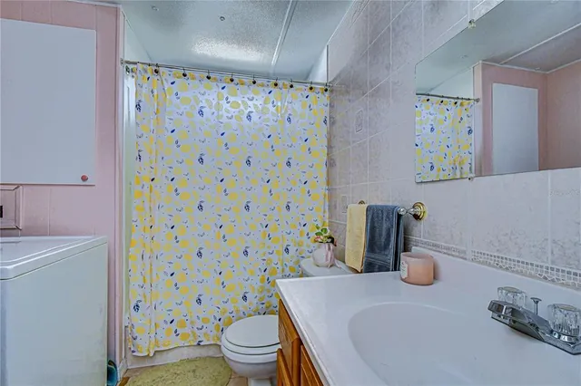 a bathroom with a sink mirror vanity and toilet