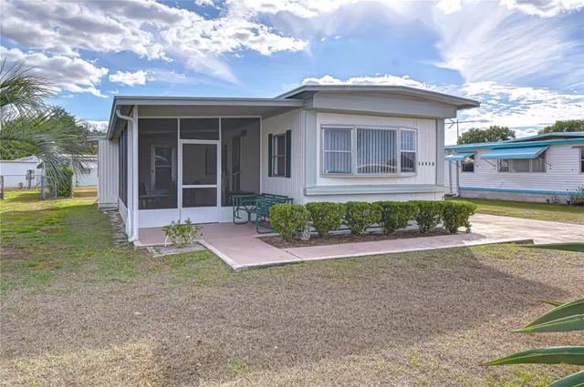 a view of a house with a yard and plants