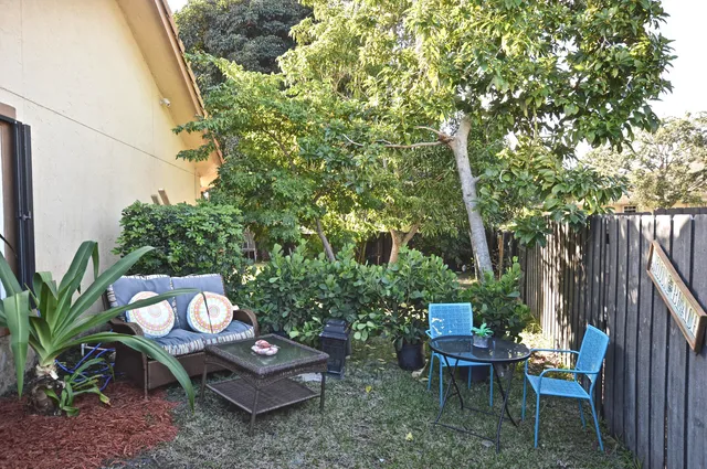 a view of a backyard with sitting area