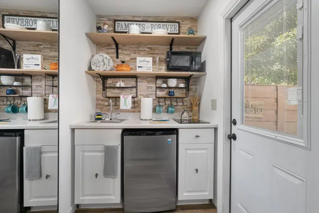 a kitchen with stainless steel appliances granite countertop a sink and cabinets