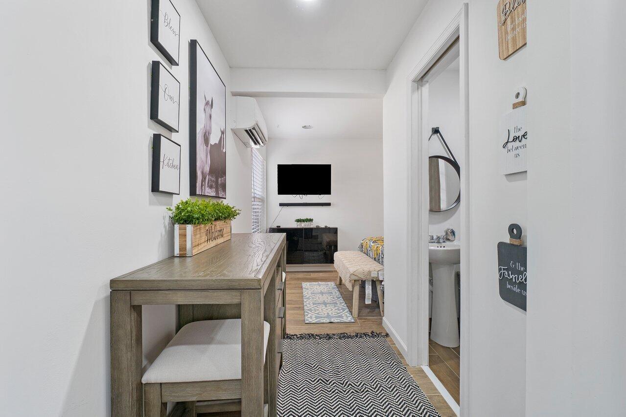 1401 Mystic Court, Unit 1BEDROOM GUESTHOUSE Wellington, FL 33414 - Photo 5 of 12 a view of hall way with furniture and wooden floor