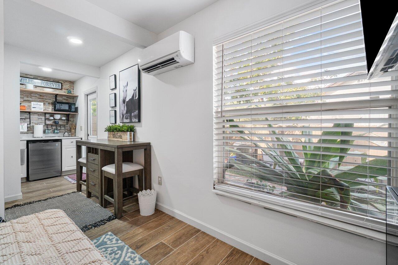 1401 Mystic Court, Unit 1BEDROOM GUESTHOUSE Wellington, FL 33414 - Photo 6 of 12 a kitchen with granite countertop a refrigerator and a sink