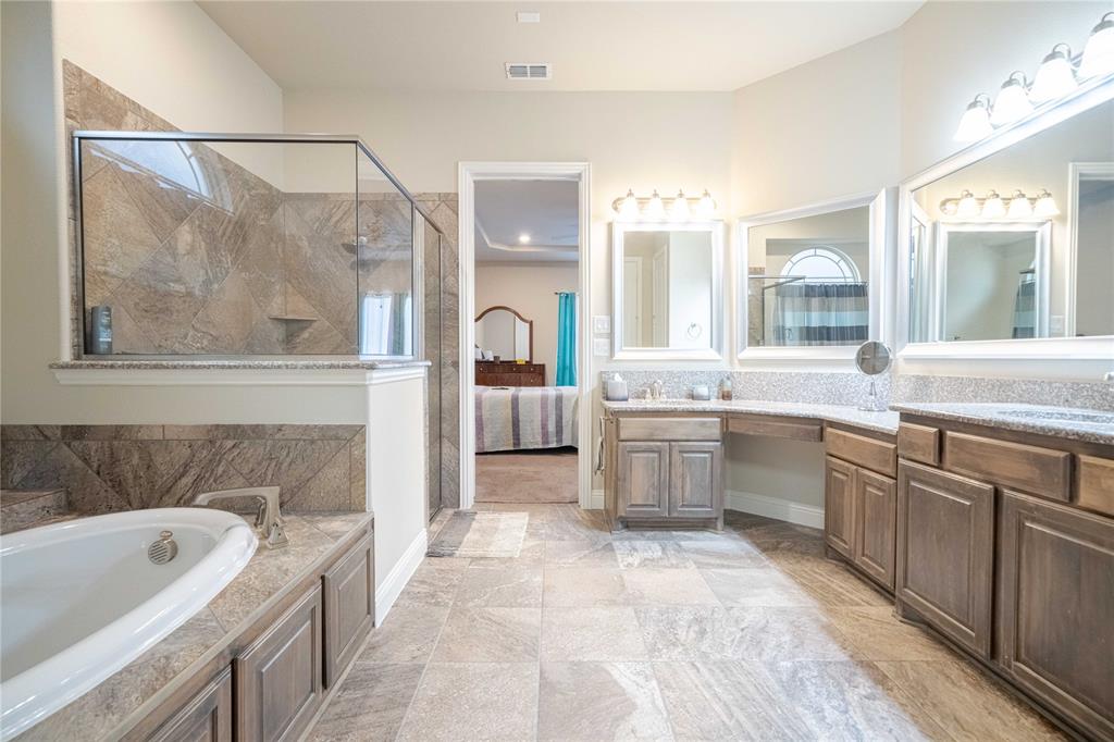 2630 Flat Bush Avenue Midlothian, TX 76065 - Photo 15 of 32 a bathroom with a tub a sink and mirror