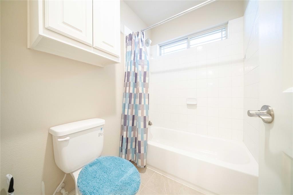 2630 Flat Bush Avenue Midlothian, TX 76065 - Photo 22 of 32 a bathroom with a shower a toilet and a window