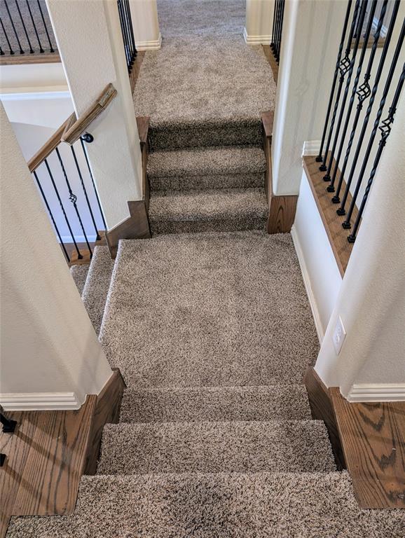 2630 Flat Bush Avenue Midlothian, TX 76065 - Photo 24 of 32 a view of staircase with white walls and railing