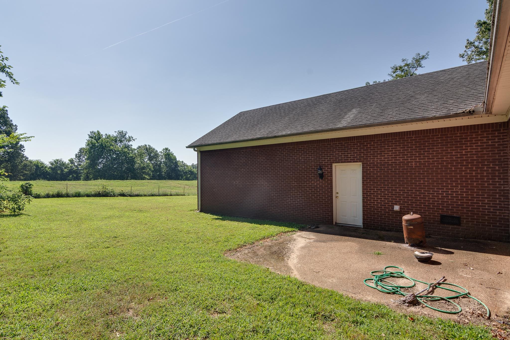 9102 Highway 76 Stanton, TN 38069 - Photo 25 of 27 View of green lawn with a patio area