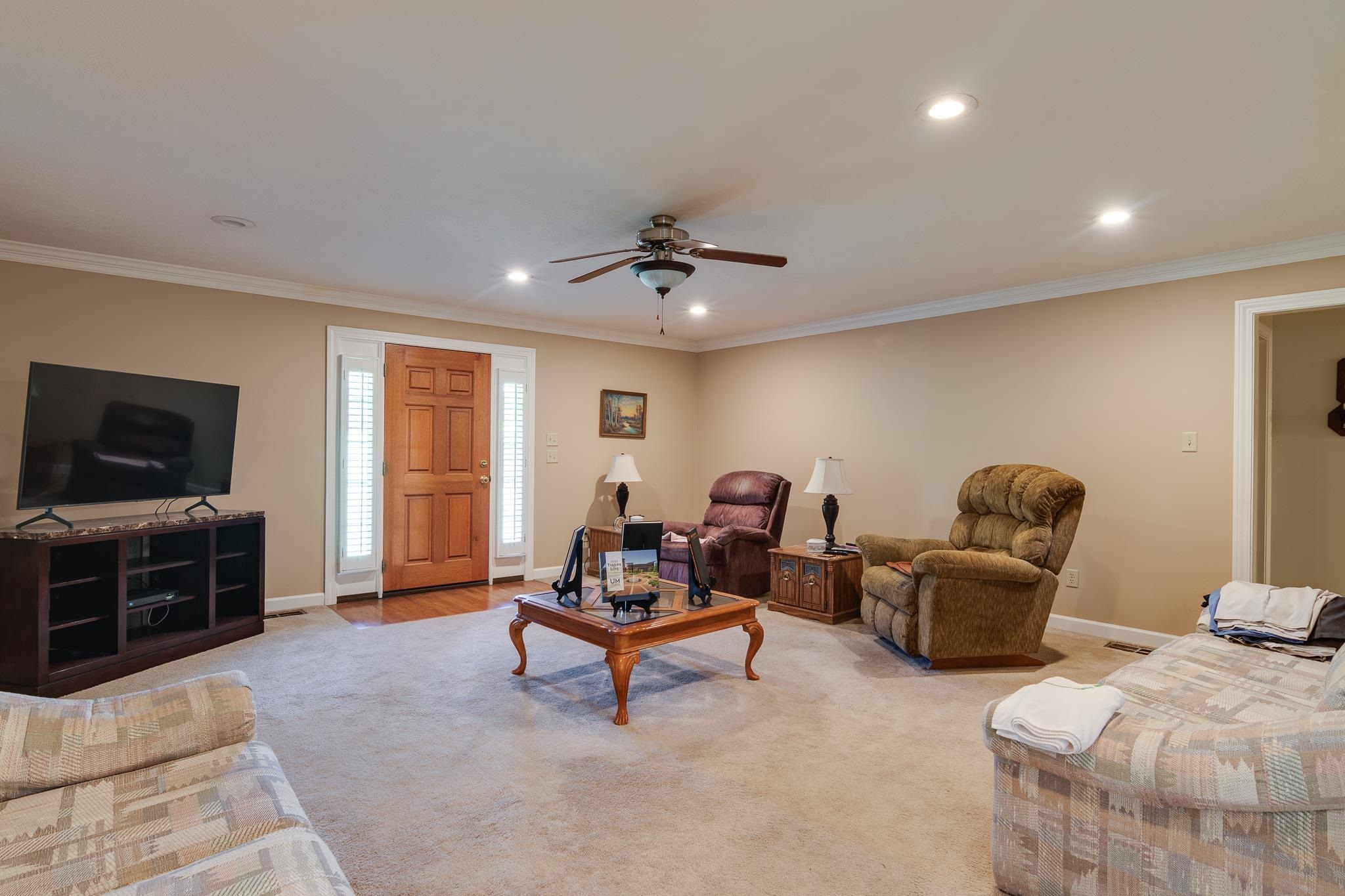 9102 Highway 76 Stanton, TN 38069 - Photo 5 of 27 Living room with recessed lighting, a ceiling fan, light carpet, and crown molding