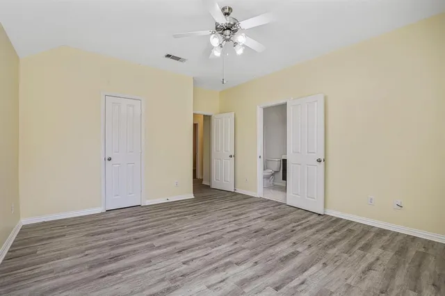 a view of an empty room and wooden floor