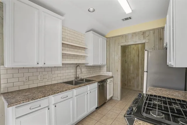 a kitchen that has a sink and a stove