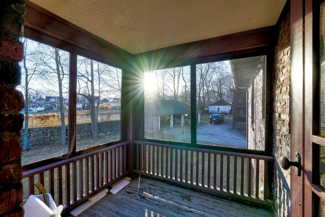 a view of a porch with wooden floor