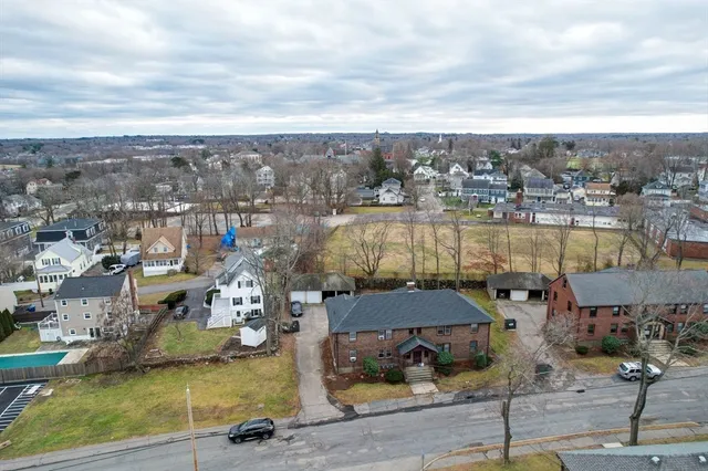 an aerial view of a houses with yard