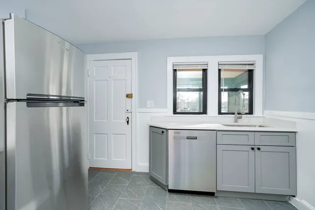 a view of a kitchen with white cabinets