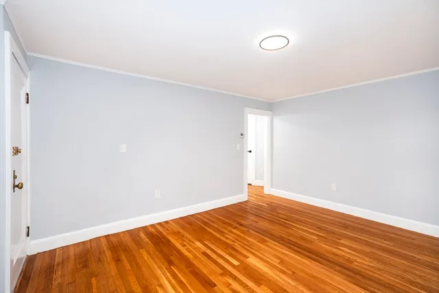 a view of room with wooden floor