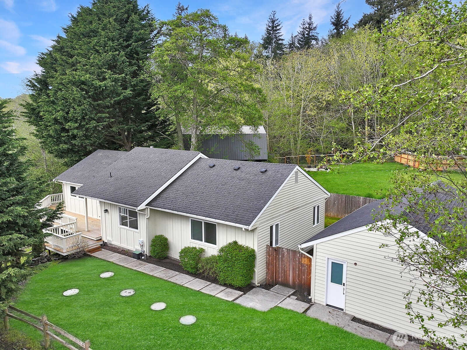 a aerial view of a house with a yard and a garden