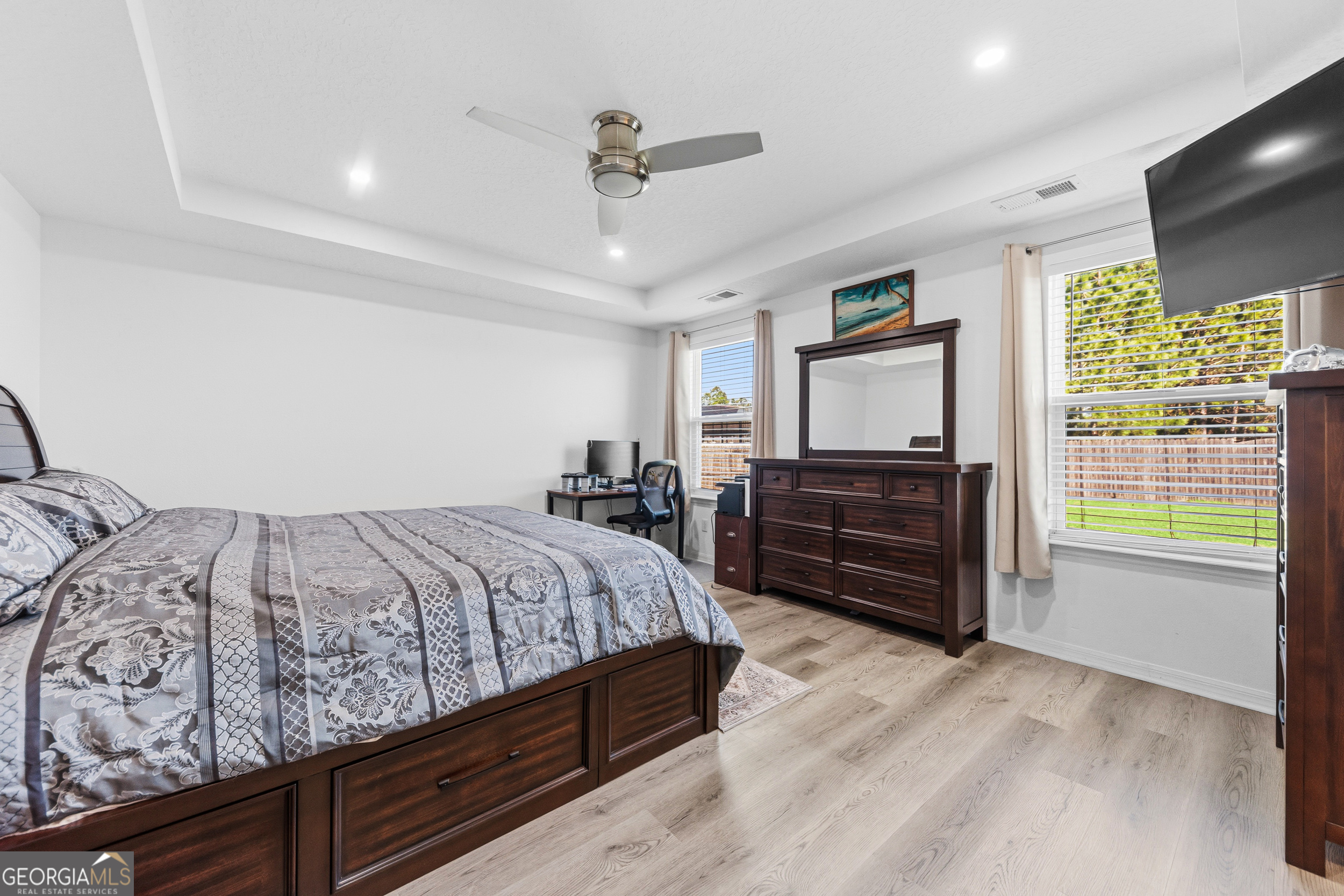 135 Walnut Way Kingsland, GA 31548 - Photo 20 of 35 a bed room with a bed dresser and a television