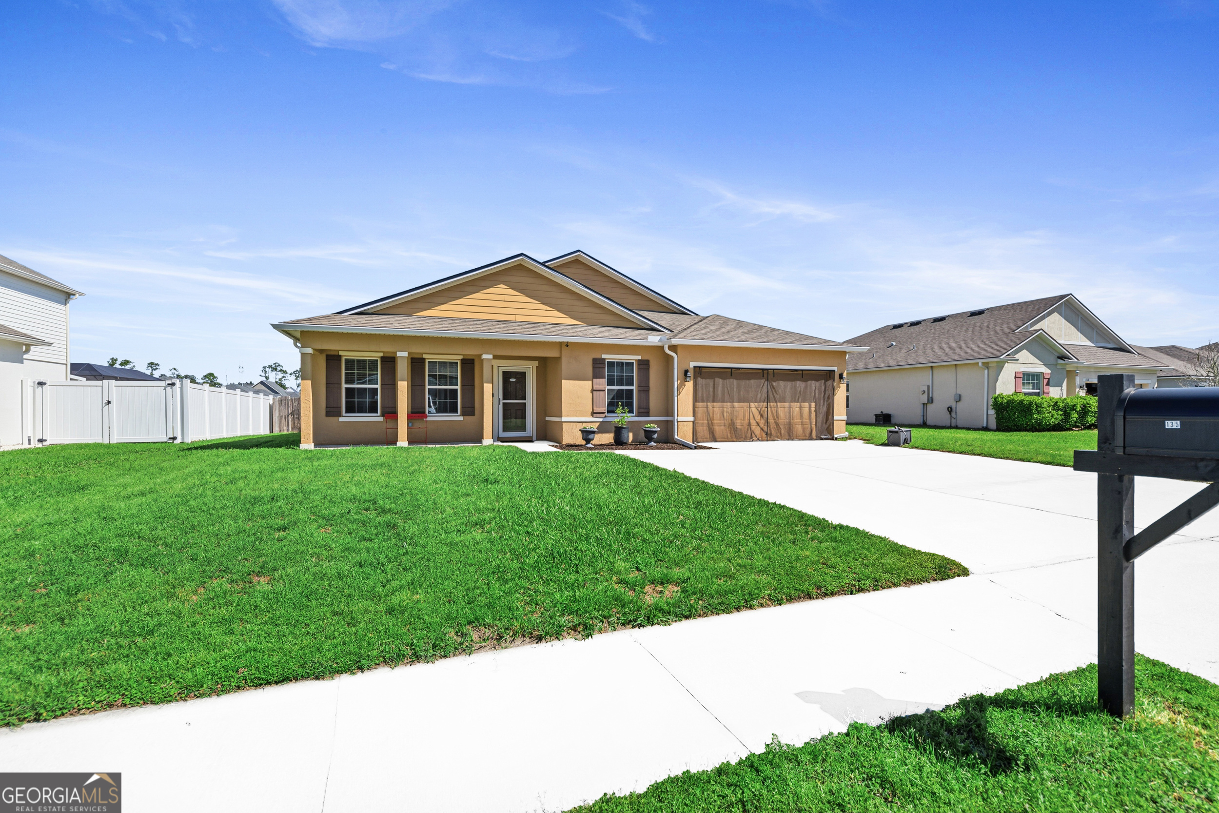 135 Walnut Way Kingsland, GA 31548 - Photo 2 of 35 a front view of a house with a yard
