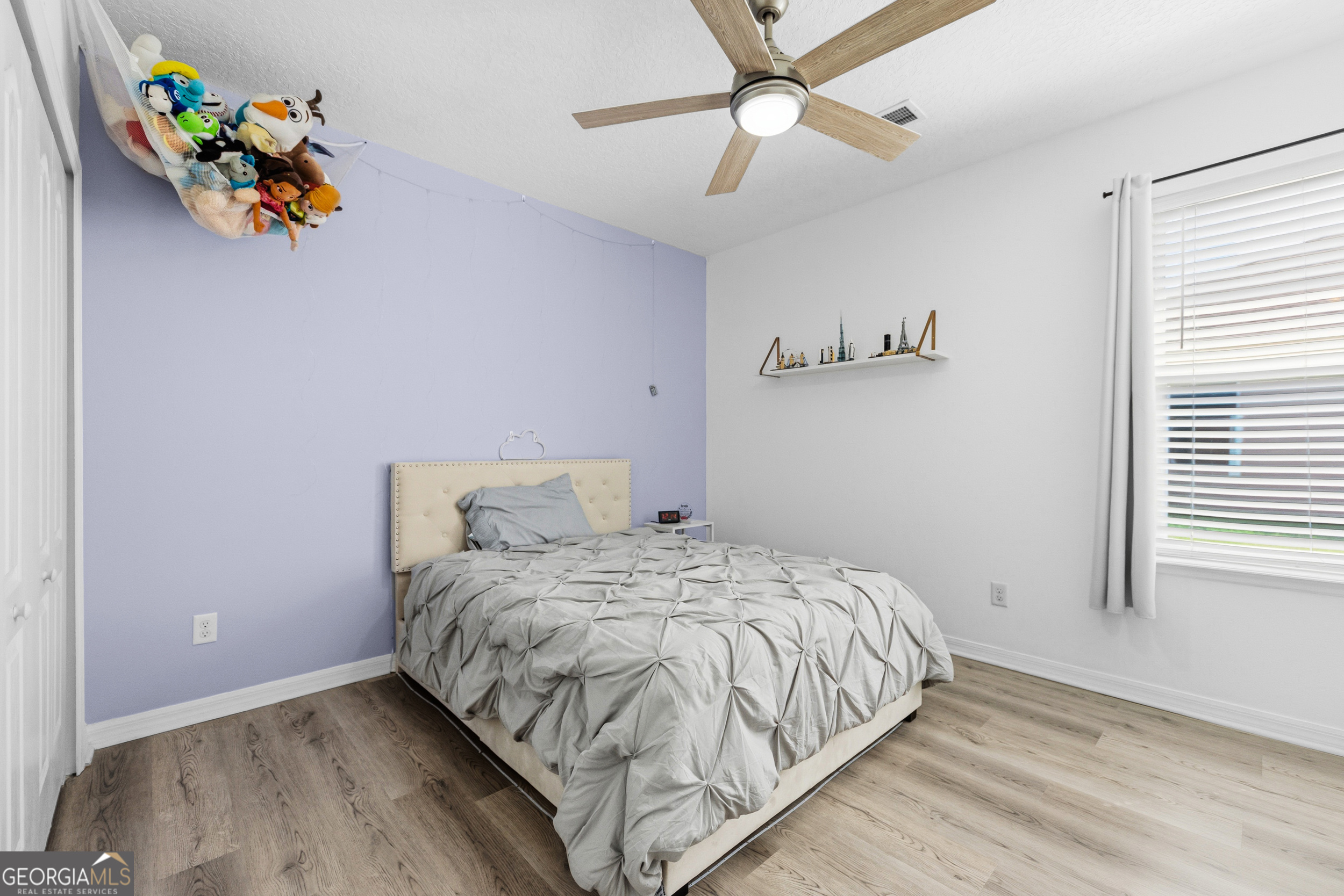 135 Walnut Way Kingsland, GA 31548 - Photo 21 of 35 a bedroom with a bed and a window