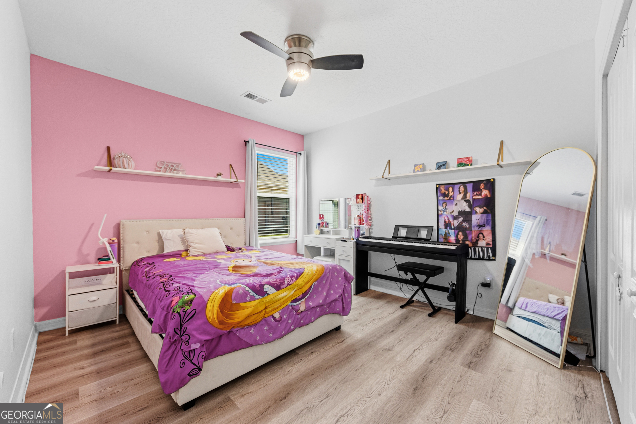 135 Walnut Way Kingsland, GA 31548 - Photo 23 of 35 a bedroom with a bed table and a chandelier