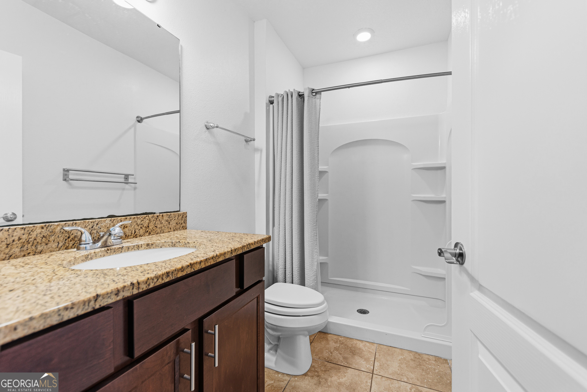135 Walnut Way Kingsland, GA 31548 - Photo 25 of 35 a bathroom with a granite countertop sink toilet and shower