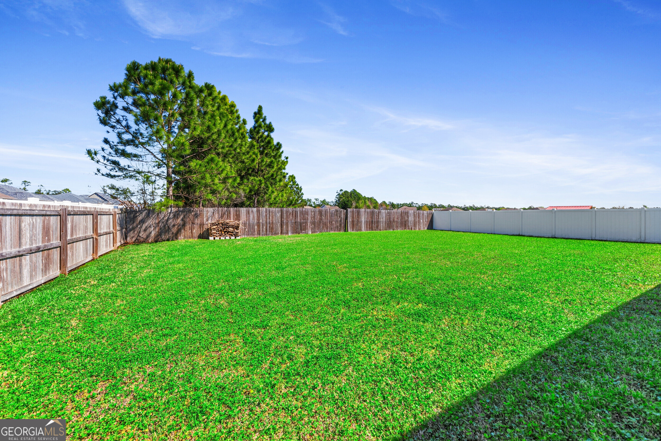 135 Walnut Way Kingsland, GA 31548 - Photo 29 of 35 a view of yard with grass and a trees in the background