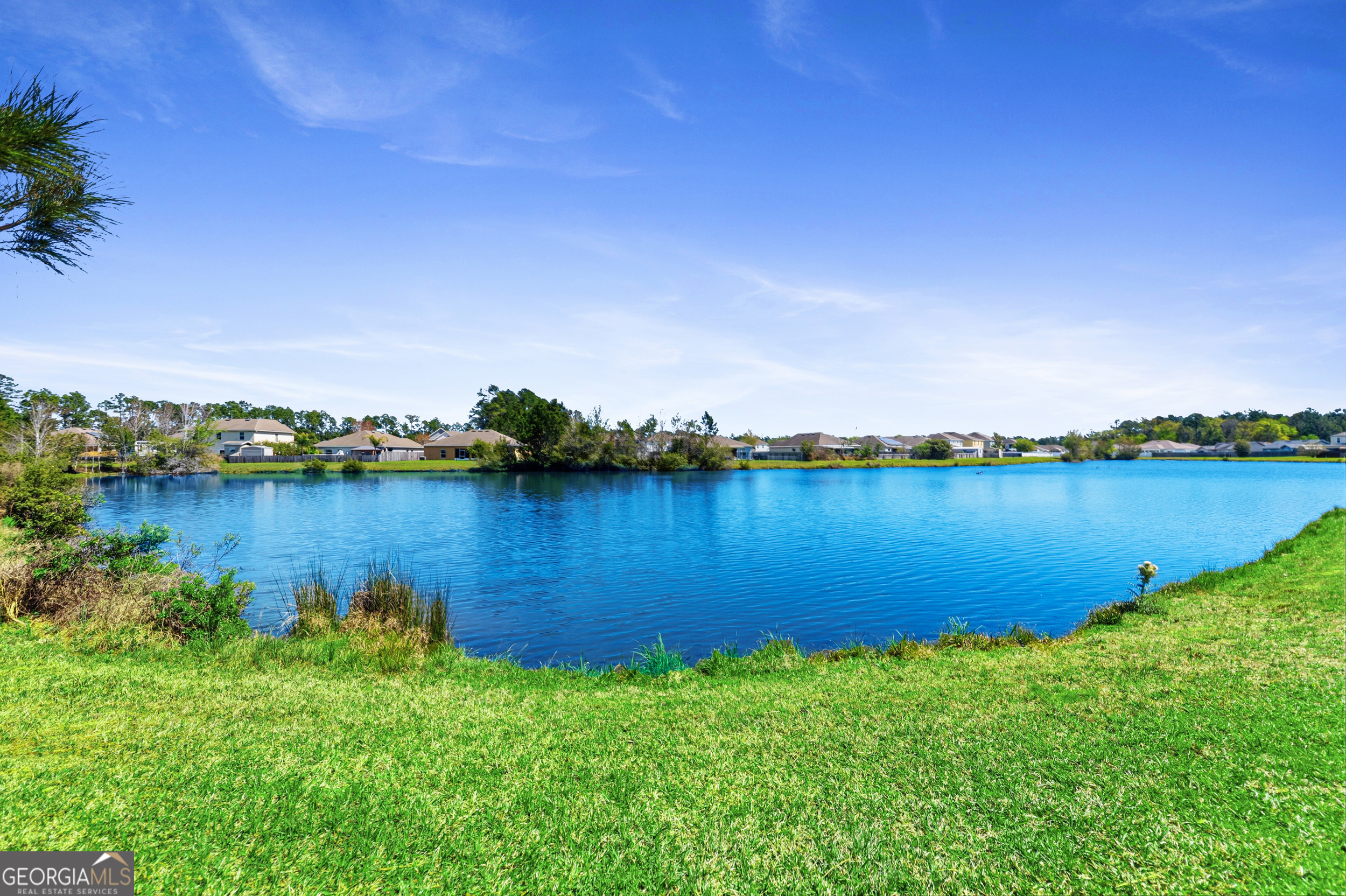 135 Walnut Way Kingsland, GA 31548 - Photo 33 of 35 a view of a lake with houses in the back