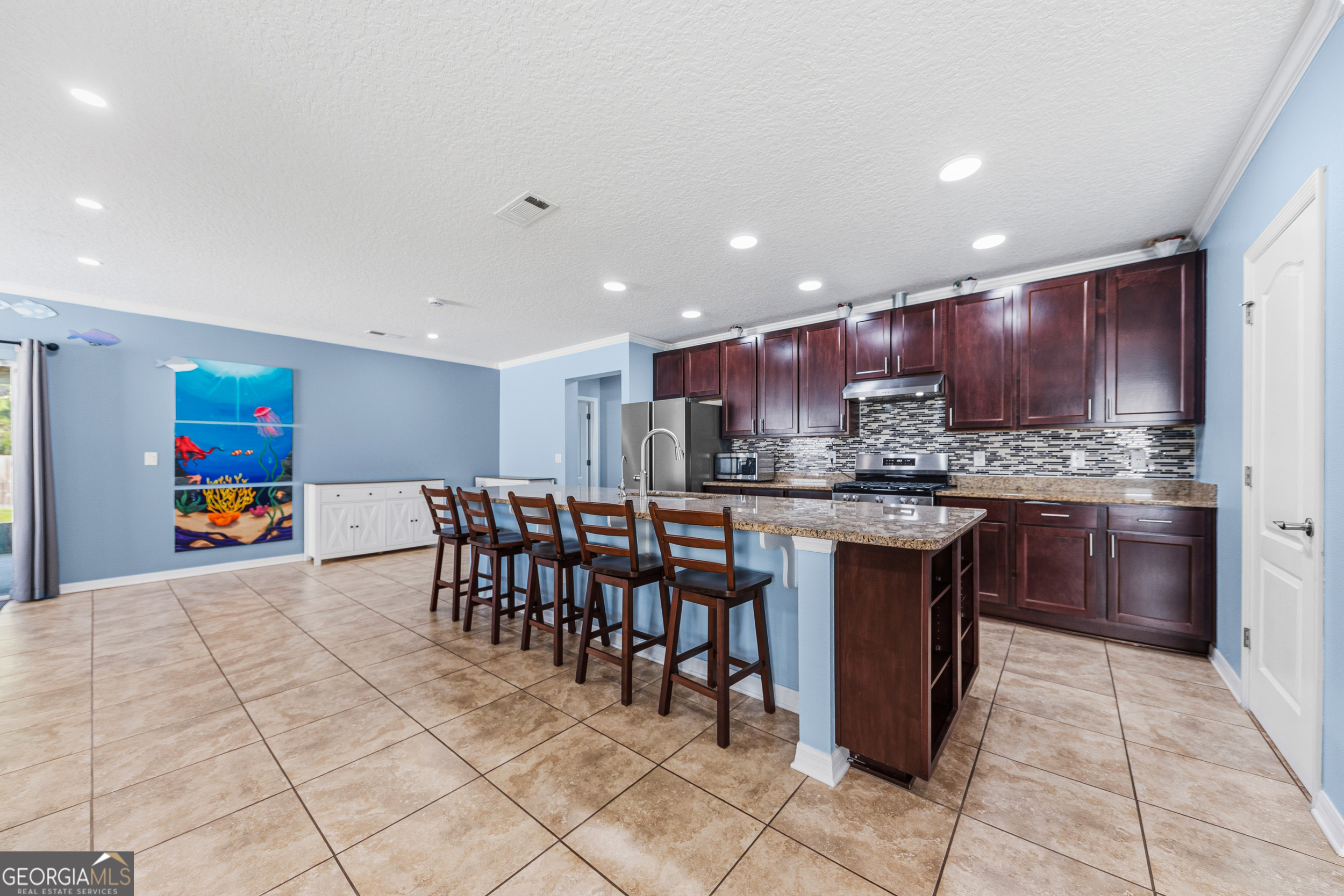 135 Walnut Way Kingsland, GA 31548 - Photo 4 of 35 a kitchen with stainless steel appliances granite countertop a table chairs sink and cabinets