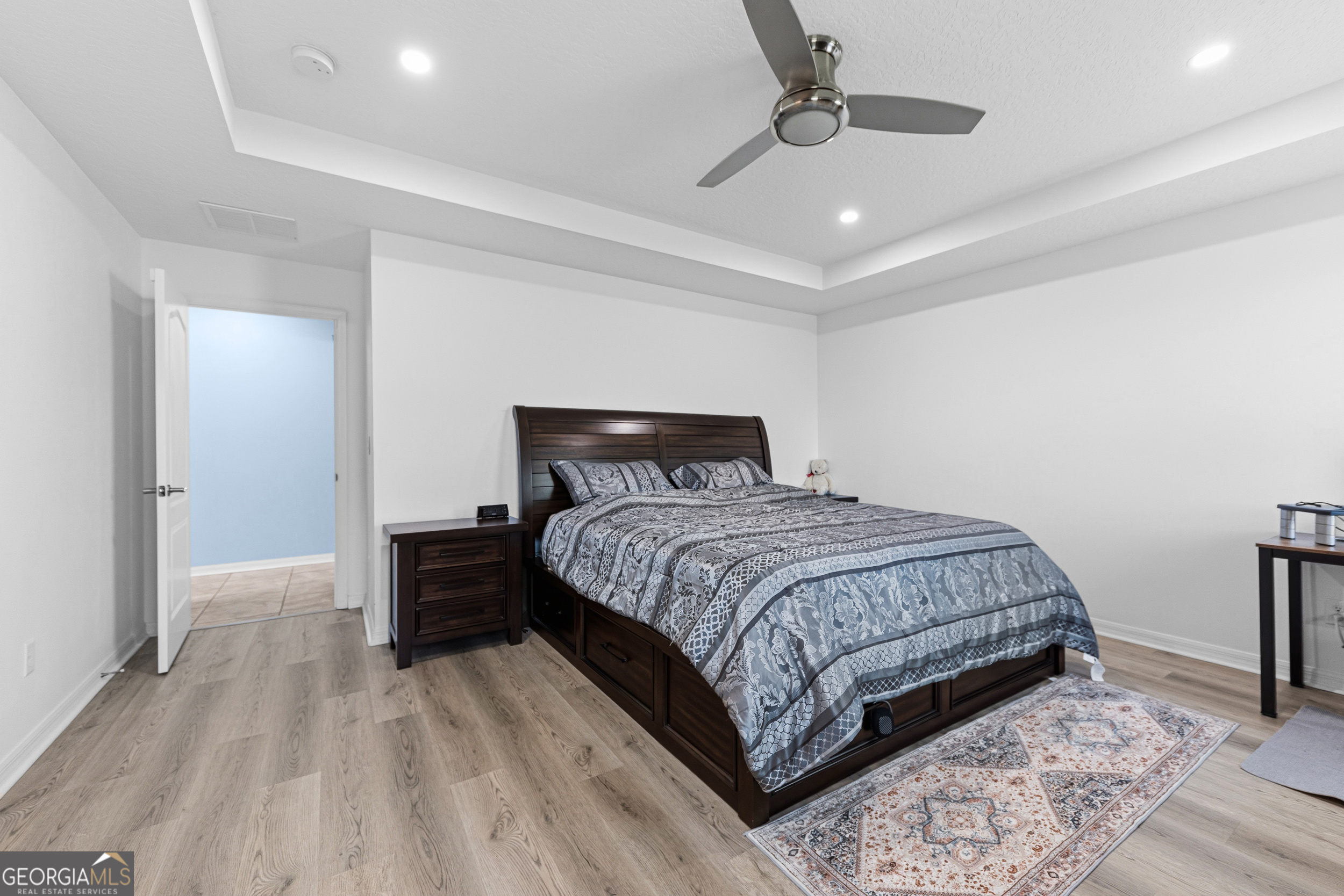 135 Walnut Way Kingsland, GA 31548 - Photo 5 of 35 a bedroom with a bed and wooden floor