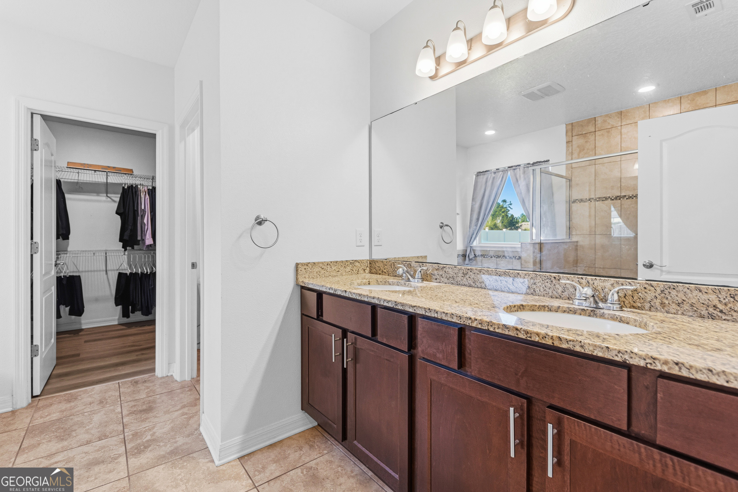 135 Walnut Way Kingsland, GA 31548 - Photo 6 of 35 a bathroom with a sink a vanity and a mirror