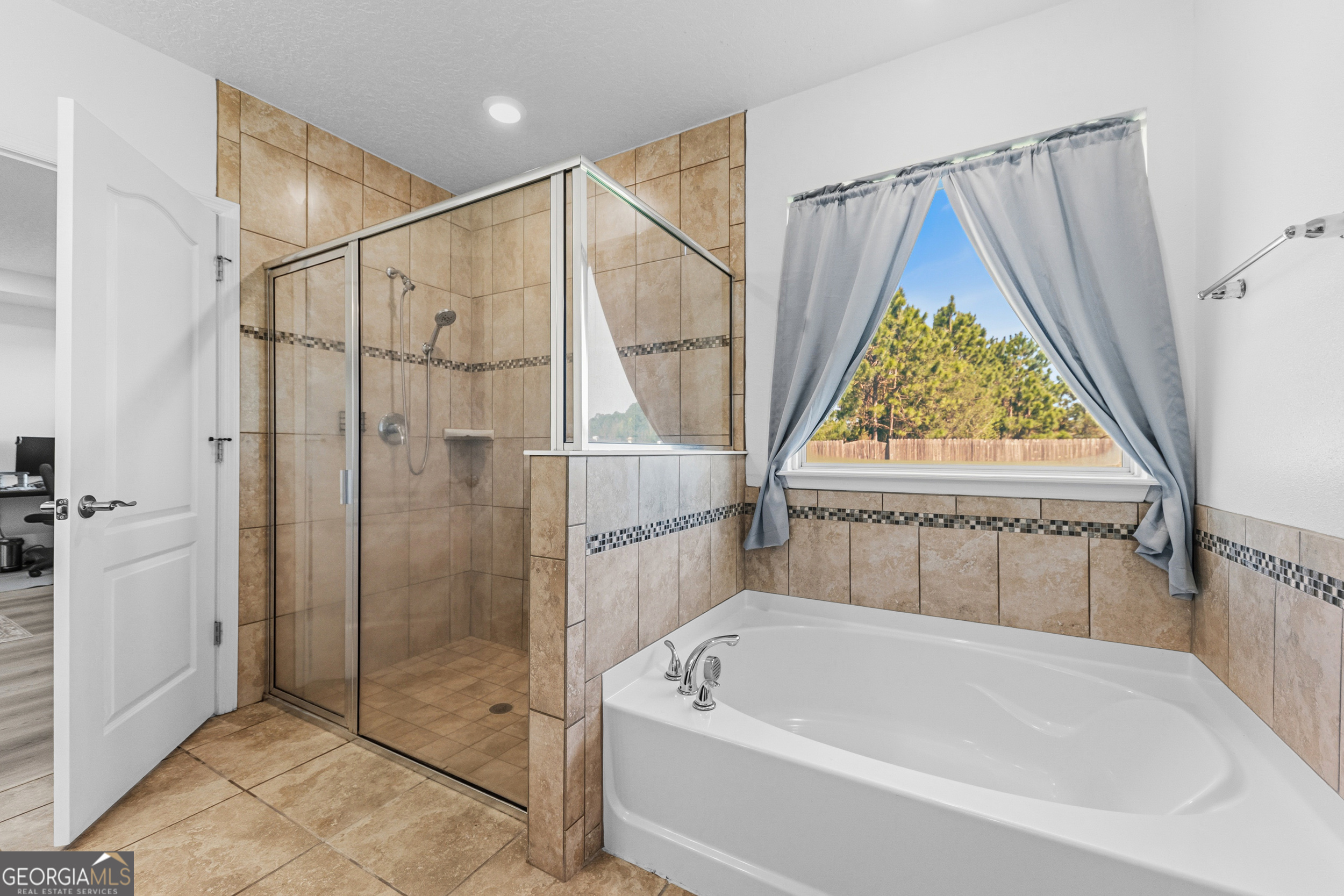 135 Walnut Way Kingsland, GA 31548 - Photo 7 of 35 a bathroom with a bath tub and a shower