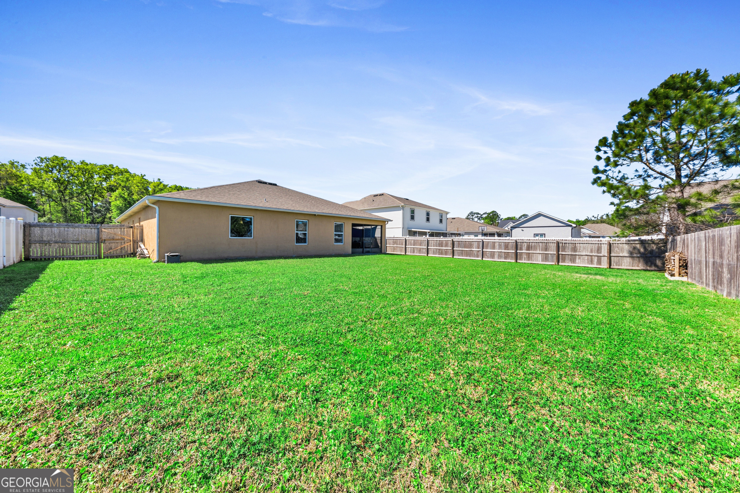 135 Walnut Way Kingsland, GA 31548 - Photo 9 of 35 a large house with a big yard and large trees