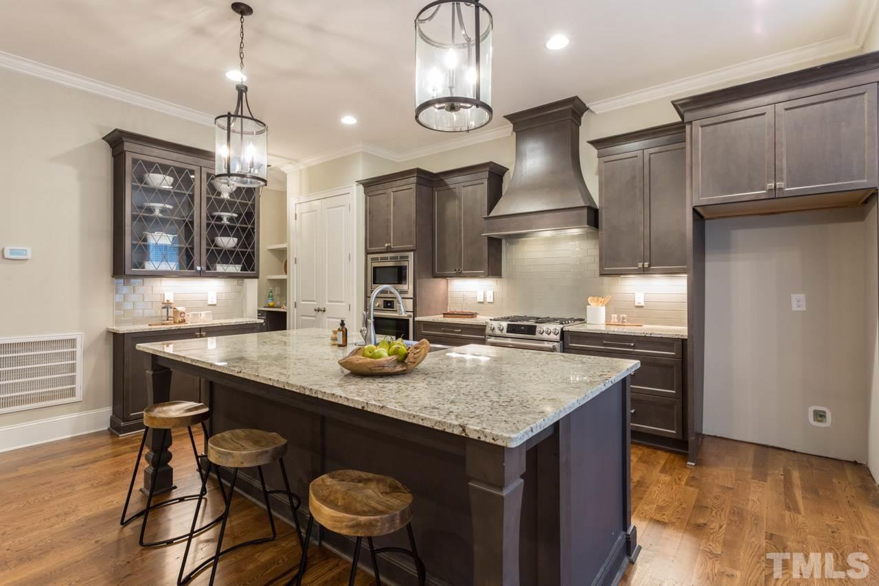 4613 Pleasant Pointe Way Raleigh, NC 27613 - Photo 4 of 25 a kitchen with stainless steel appliances granite countertop a sink a stove and a wooden floors