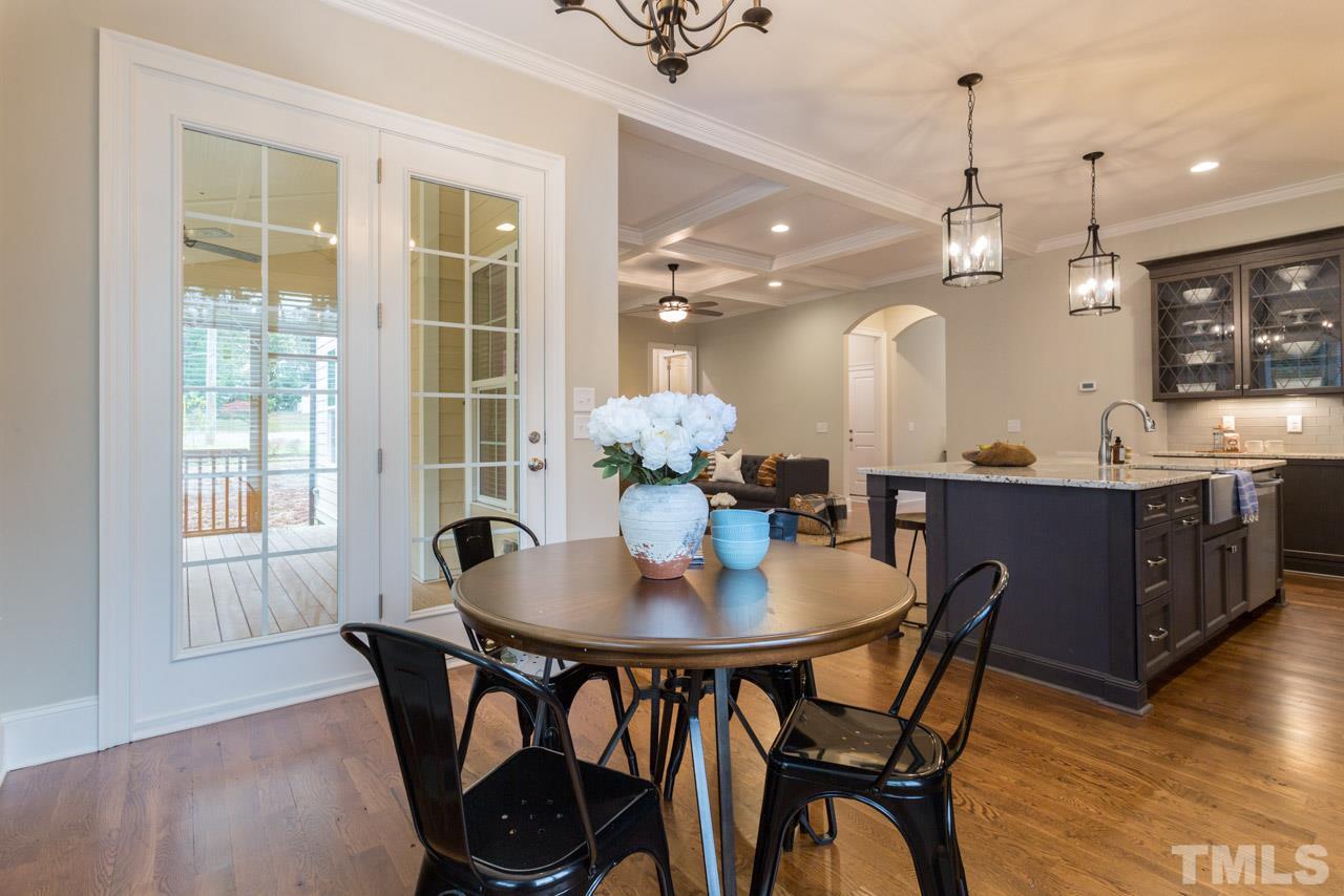 4613 Pleasant Pointe Way Raleigh, NC 27613 - Photo 8 of 25 a view of a dining room with furniture and wooden floor
