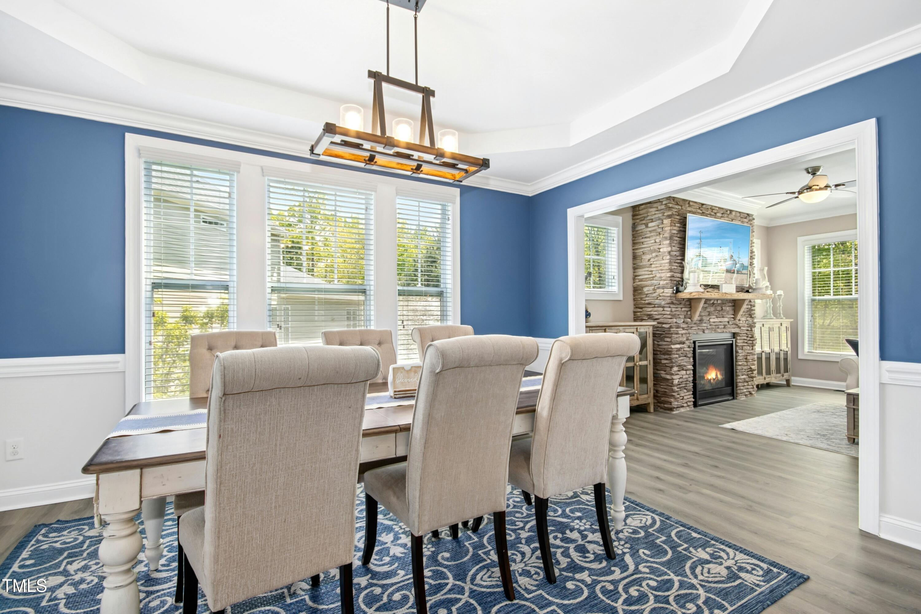 44 South Wilders Ridge Way Clayton, NC 27527 - Photo 8 of 56 a dining room with furniture a chandelier and wooden floor