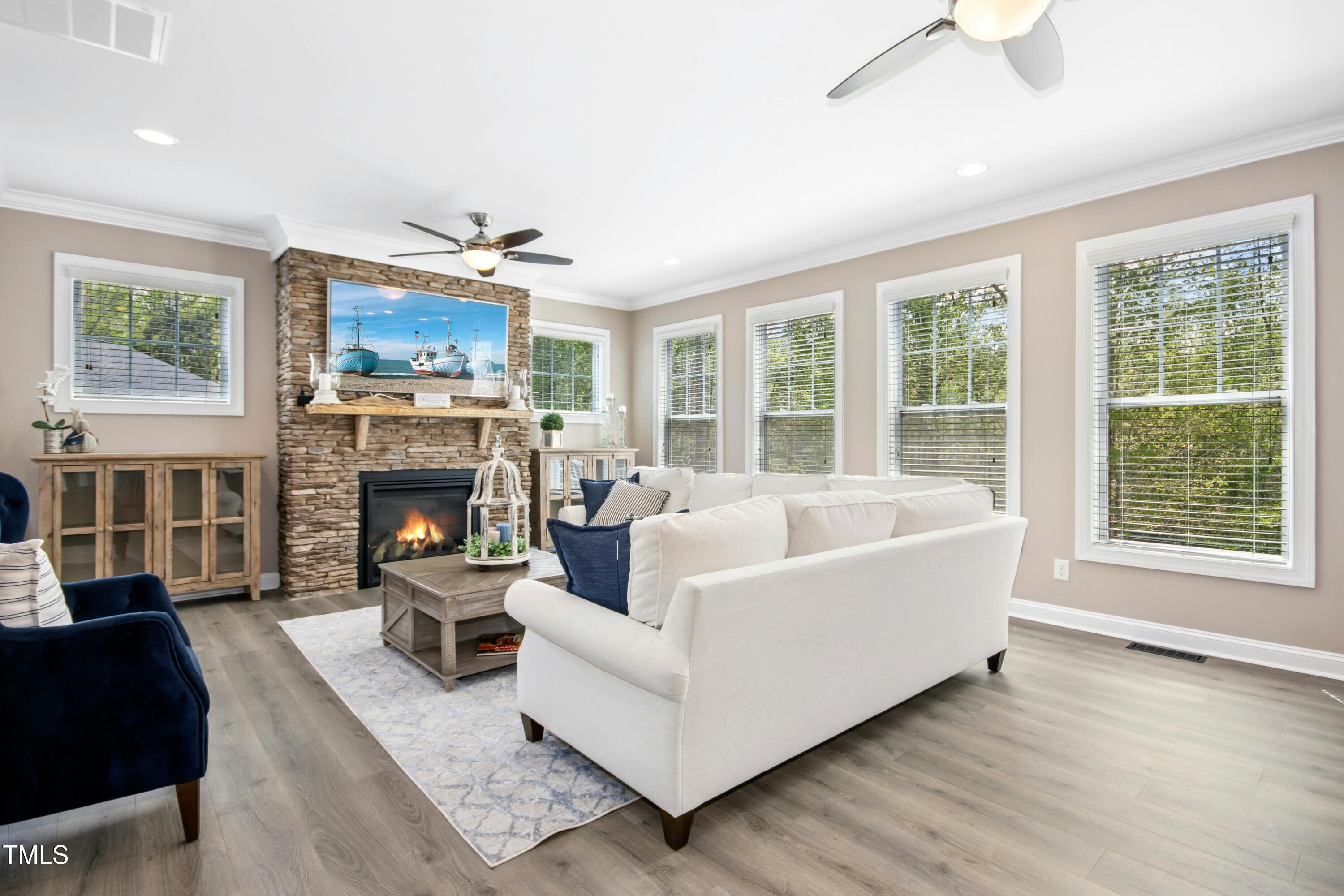 44 South Wilders Ridge Way Clayton, NC 27527 - Photo 11 of 56 a living room with furniture a fireplace and a window