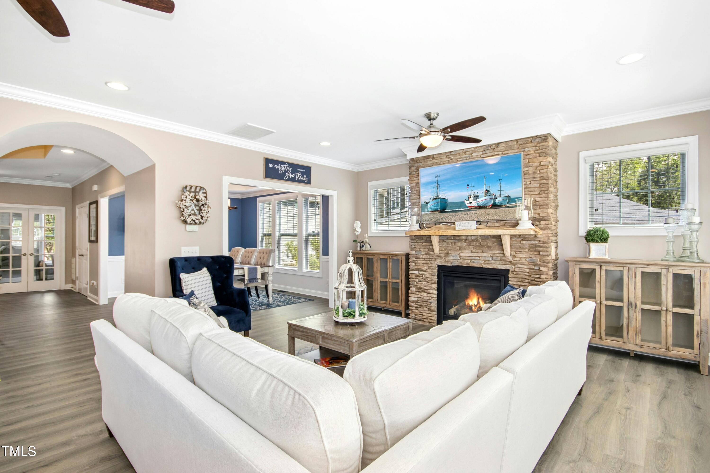44 South Wilders Ridge Way Clayton, NC 27527 - Photo 12 of 56 a living room with furniture a fireplace and a large window