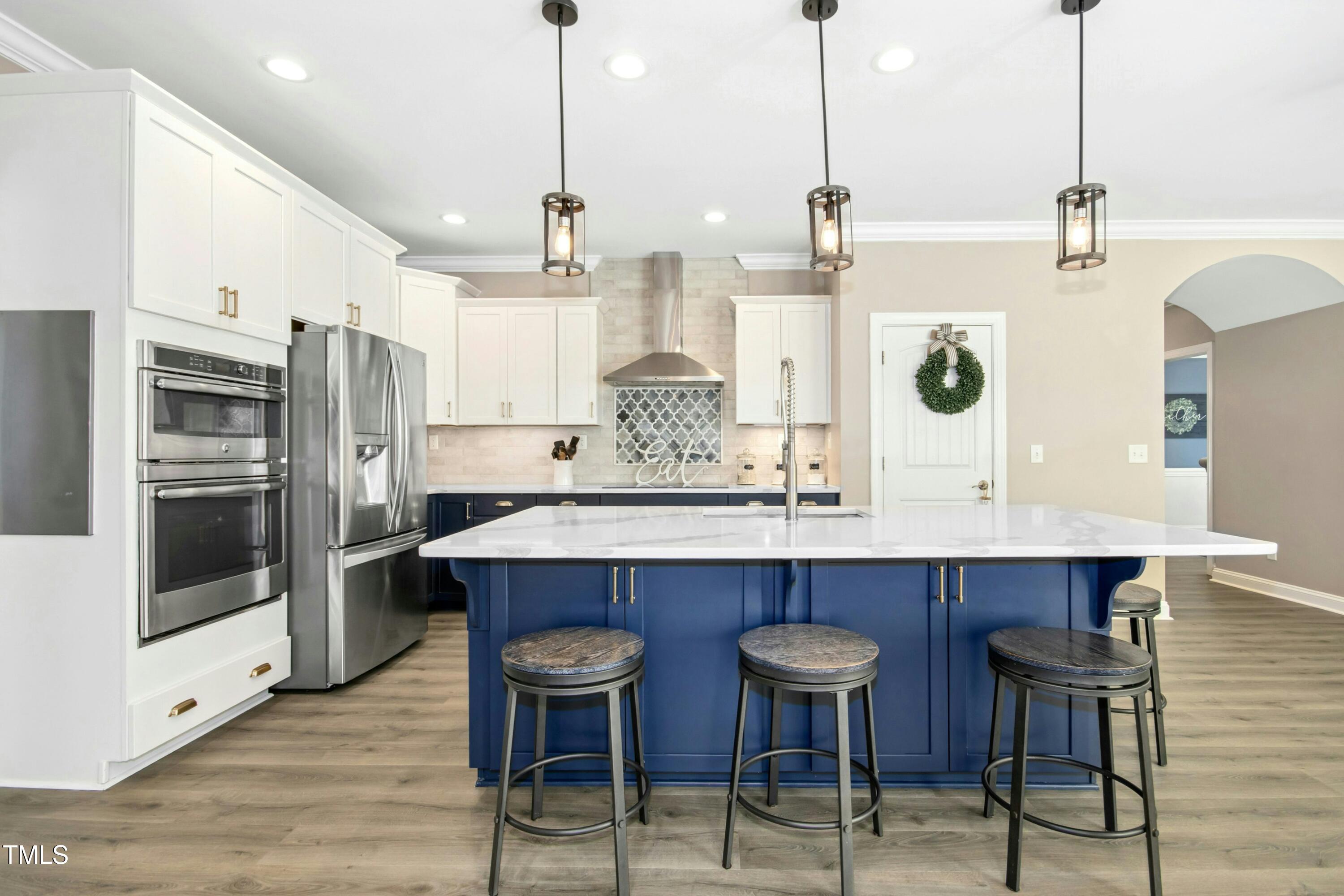 44 South Wilders Ridge Way Clayton, NC 27527 - Photo 16 of 56 a kitchen with stainless steel appliances a dining table chairs and wooden floor