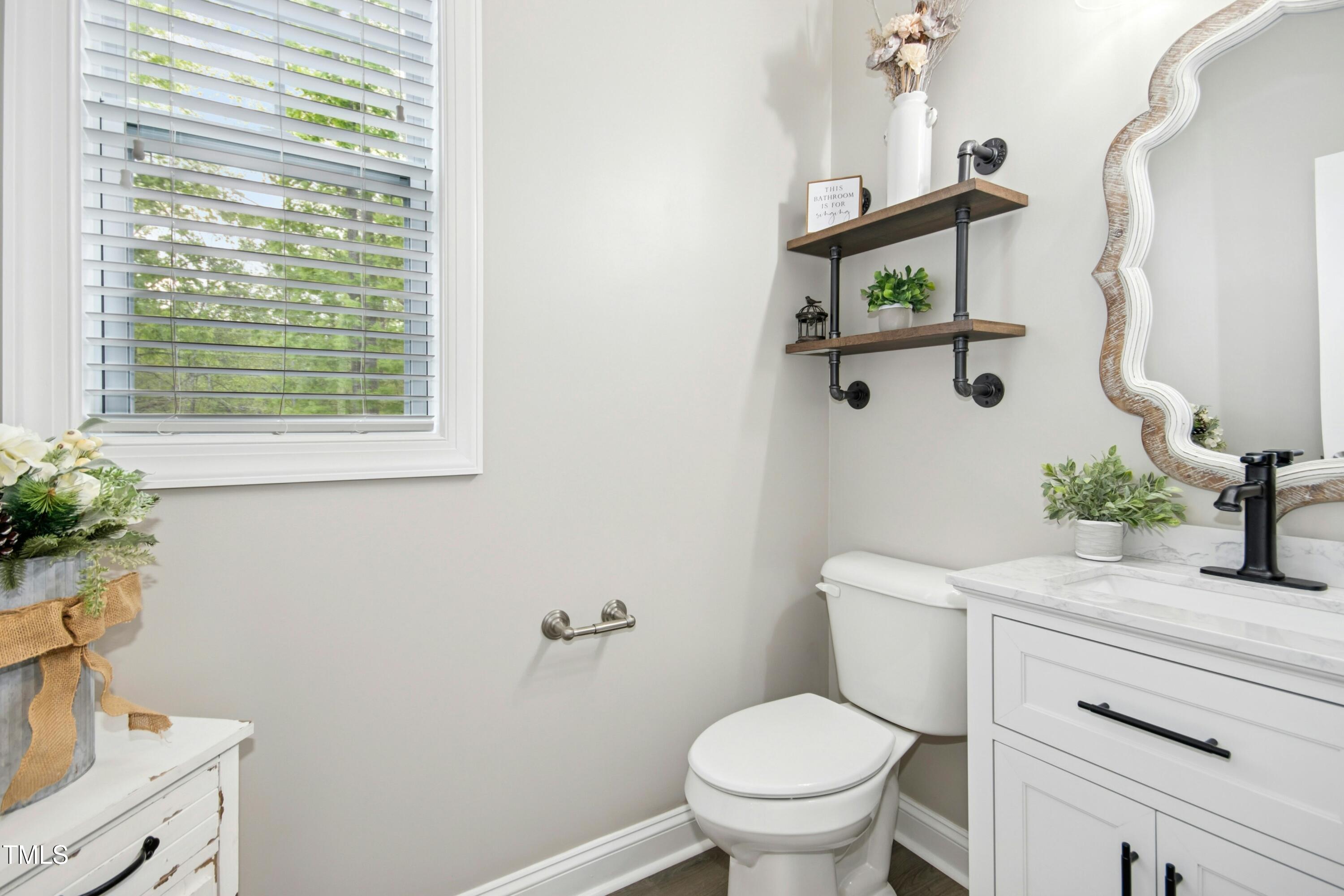 44 South Wilders Ridge Way Clayton, NC 27527 - Photo 21 of 56 a bathroom with a toilet sink and mirror