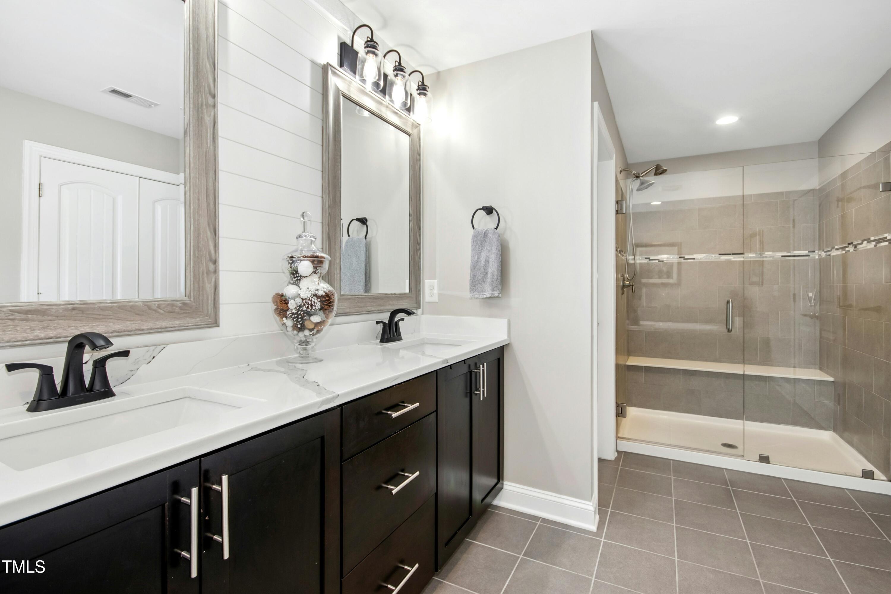 44 South Wilders Ridge Way Clayton, NC 27527 - Photo 28 of 56 a bathroom with a double vanity sink mirror double and shower