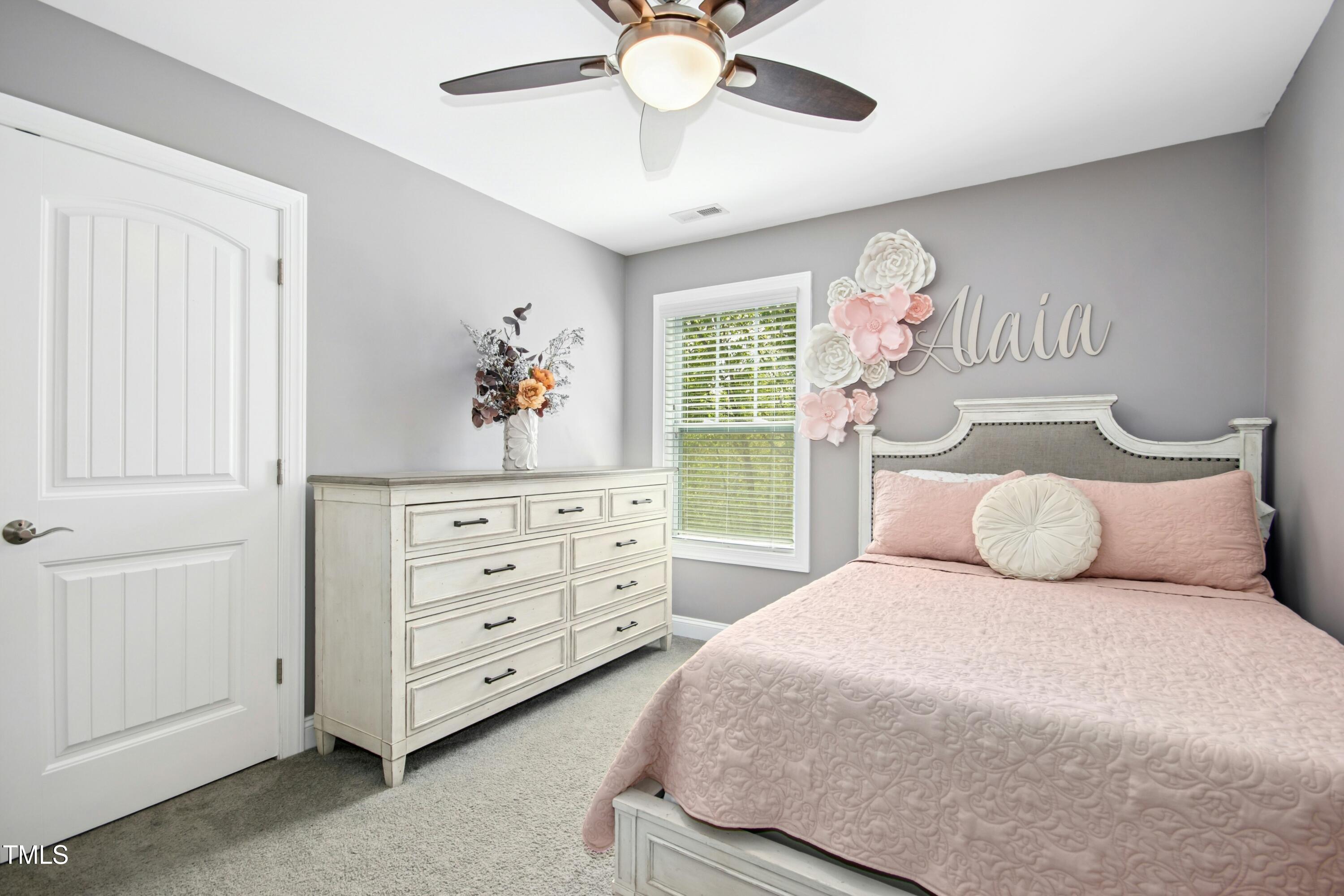44 South Wilders Ridge Way Clayton, NC 27527 - Photo 31 of 56 a bedroom with a bed and a chandelier