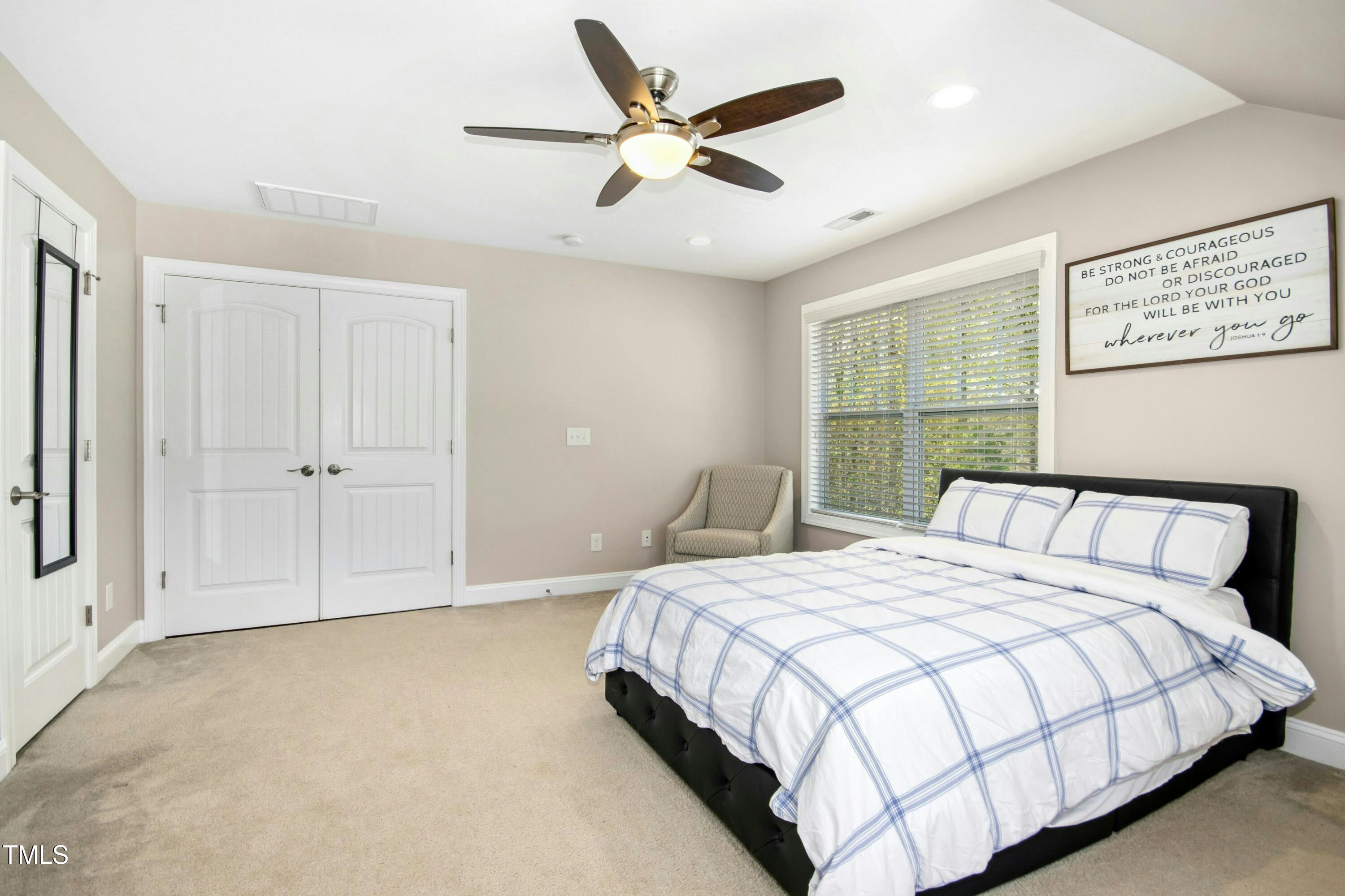 44 South Wilders Ridge Way Clayton, NC 27527 - Photo 33 of 56 a bedroom with a large bed and a large window