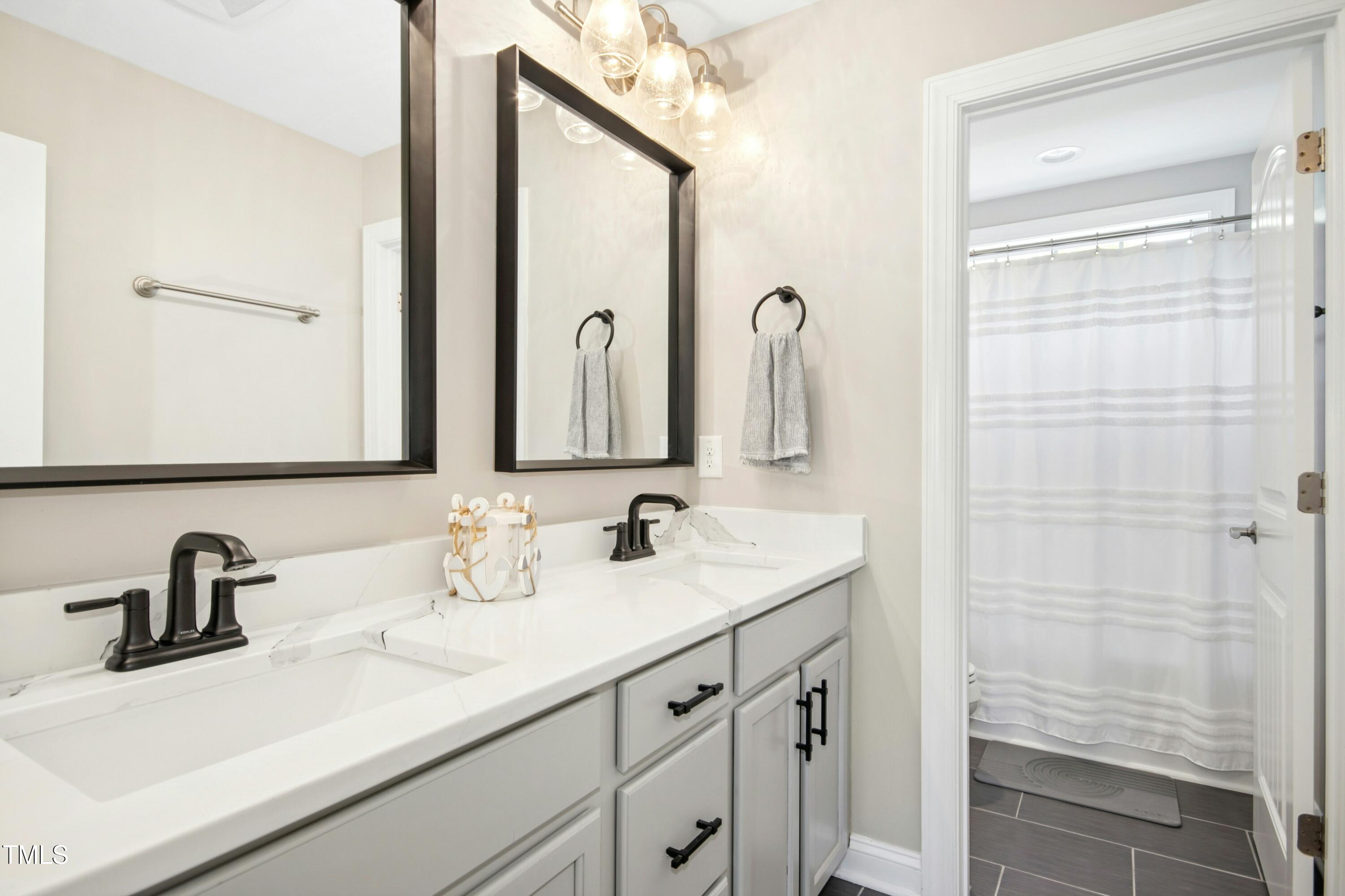 44 South Wilders Ridge Way Clayton, NC 27527 - Photo 35 of 56 a bathroom with a double vanity sink and a mirror
