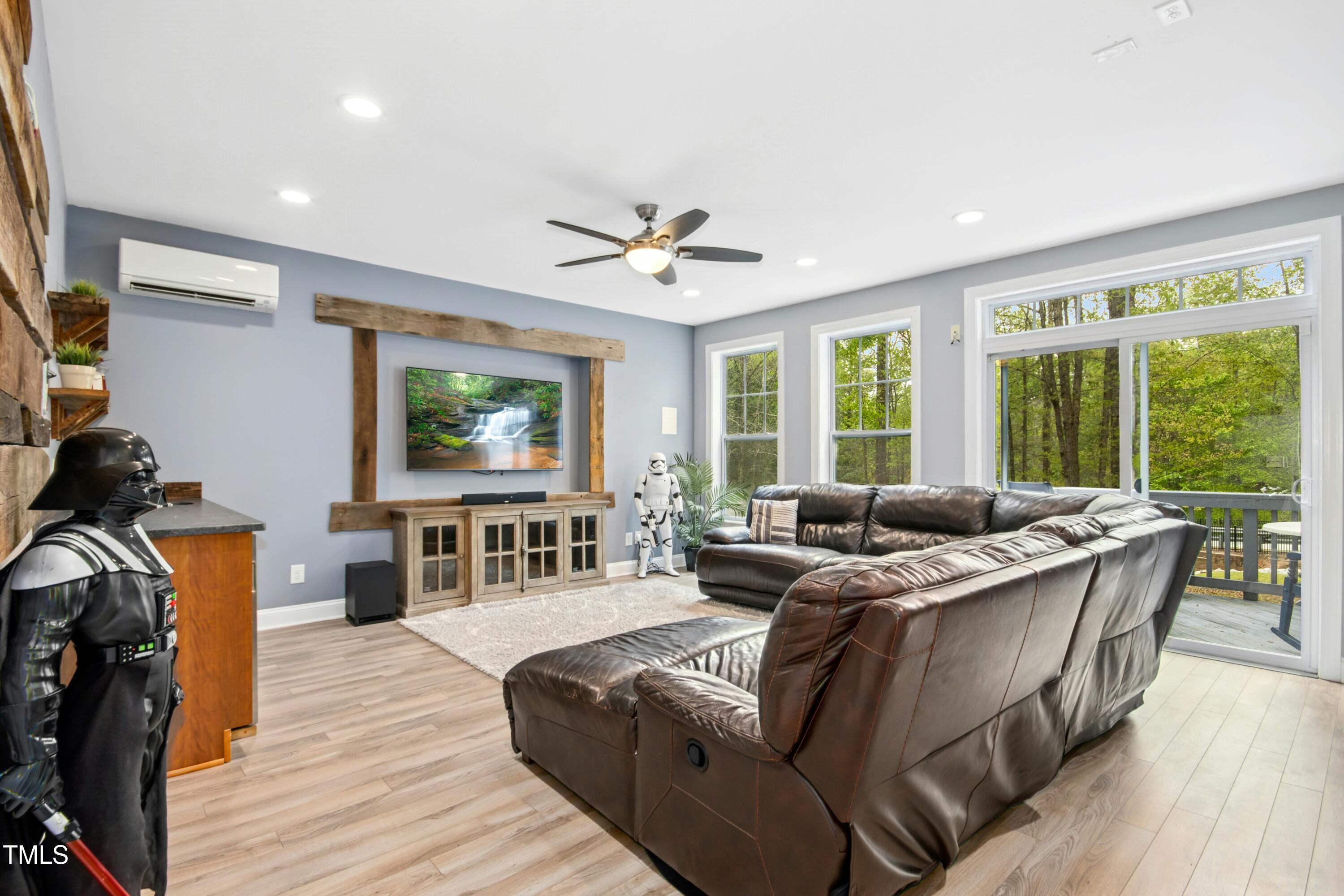 44 South Wilders Ridge Way Clayton, NC 27527 - Photo 38 of 56 a living room with furniture and a flat screen tv