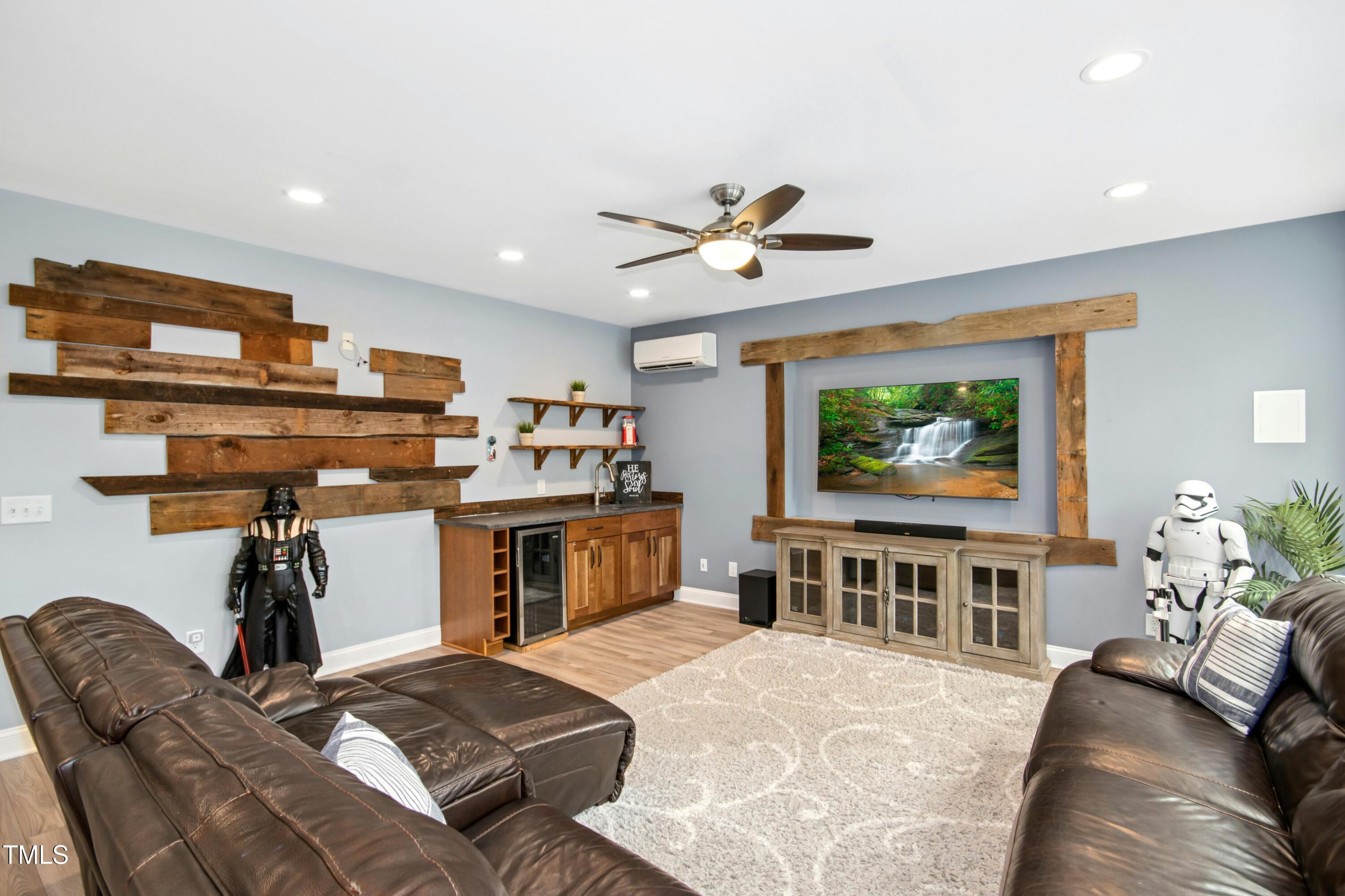 44 South Wilders Ridge Way Clayton, NC 27527 - Photo 39 of 56 a living room with furniture and a flat screen tv