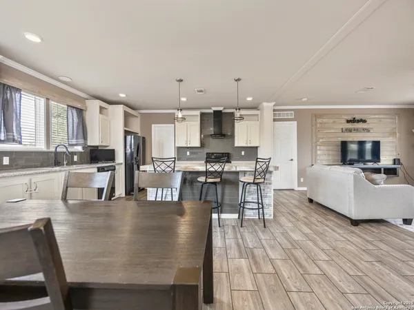 a living room with stainless steel appliances kitchen island granite countertop furniture and a kitchen view