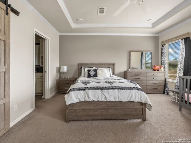 a bedroom with a bed and a tv