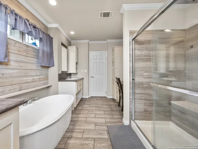 a bathroom with a bathtub and a shower