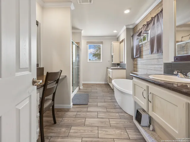 a large white kitchen with a large window