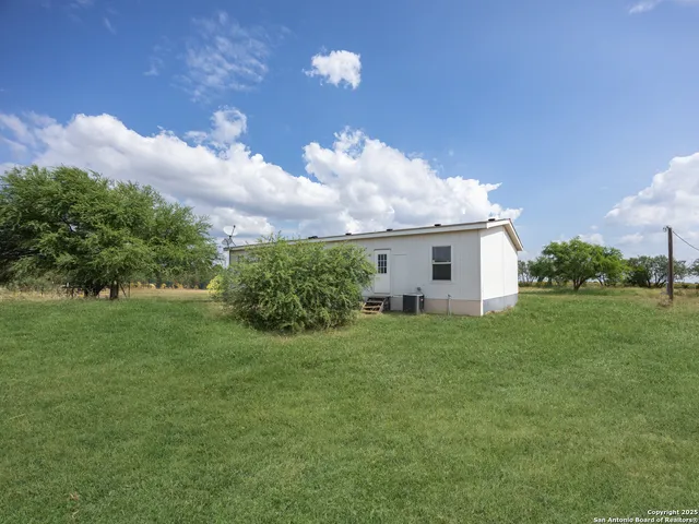 a view of a house with a big yard