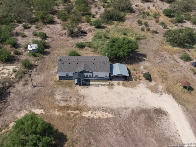 an aerial view of a house with a yard
