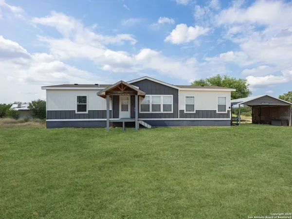 a view of a house with a backyard